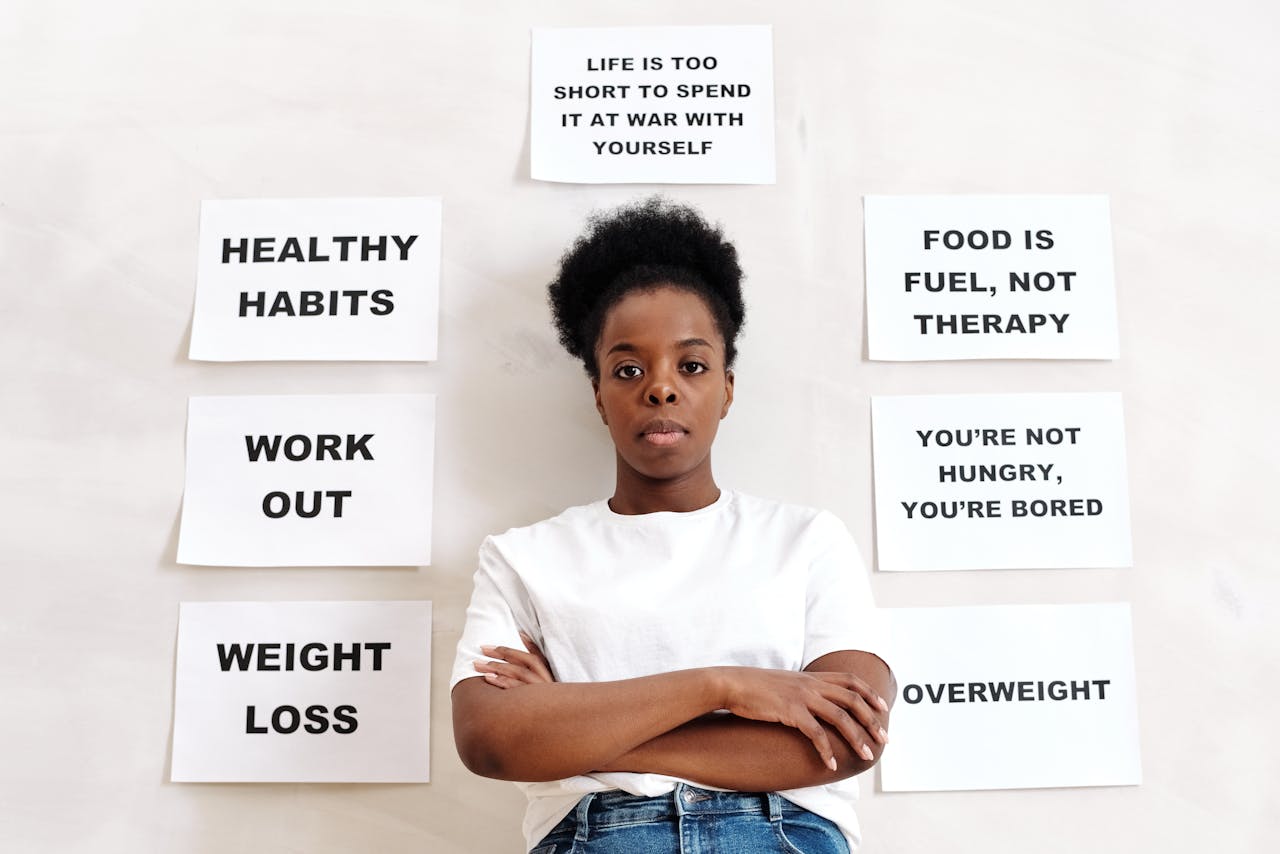 Confident woman stands surrounded by motivational messages about healthy living.