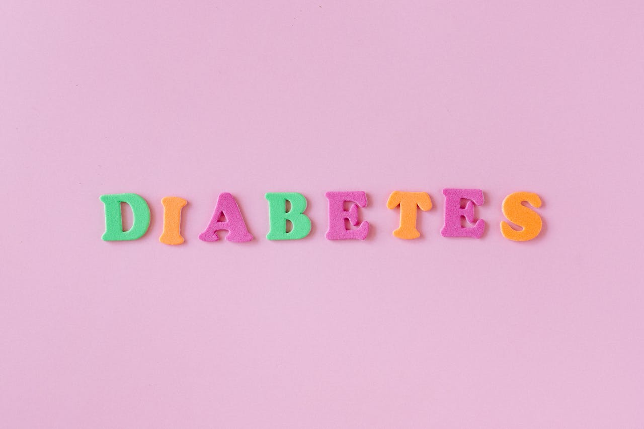 Colorful letters spelling 'diabetes' on a pink background, emphasizing health awareness.